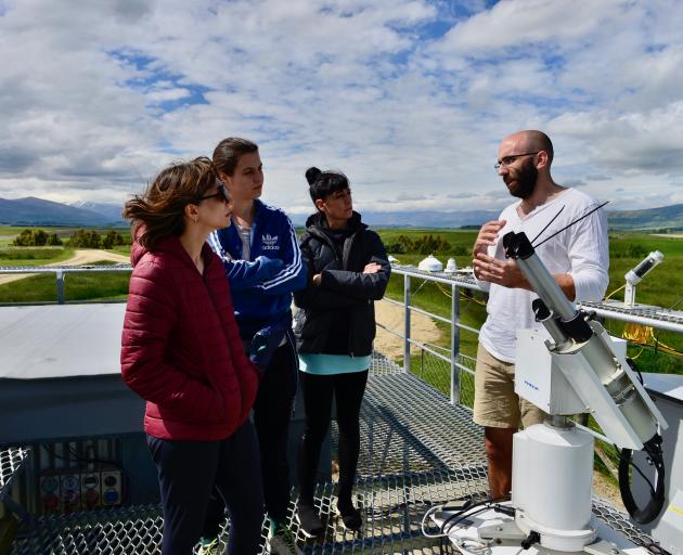 Lauder Niwa scientist Dr Alex Geddes talks to Lungsong dancers among UV instruments on the roof...