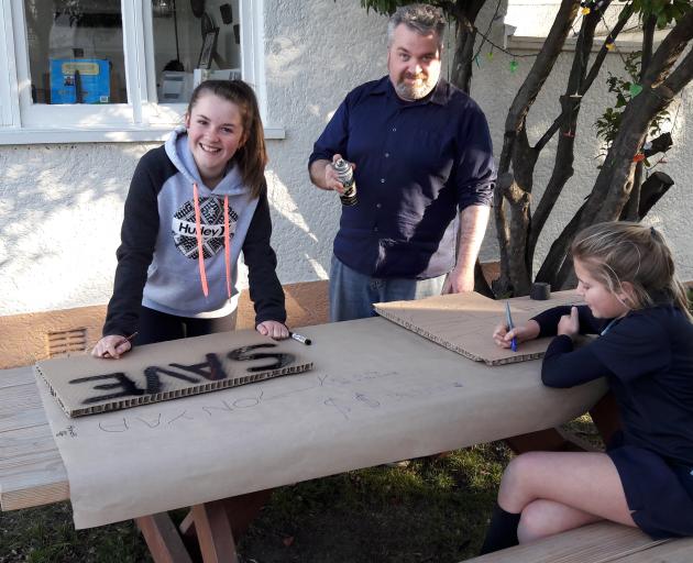 Getting their placards ready for the protest on Friday are (from left) Madi Pont (13), of Kyeburn...