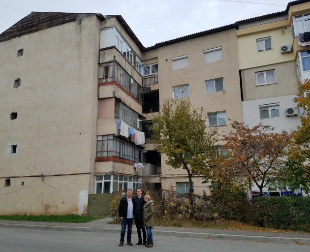 Andrei with his adopted parents Richard and Karen Moore outside the building in which he was born...