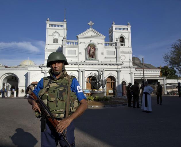 An air force officer guards St Anthony's Shrine, a day after a blast in Colombo. Photo: AP