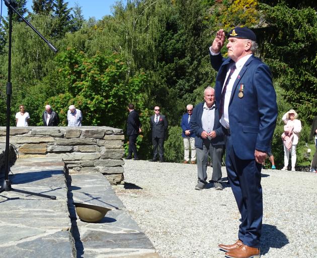 Former Queenstown RSA president Lyall McGregor salutes having laid his poppy in the infantry....