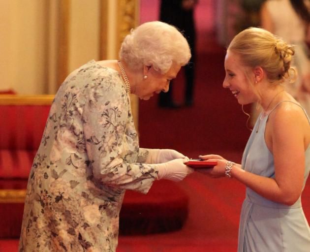 Ashleigh Smith receives her Young Leaders Award from the Queen at Buckingham Palace. Photo: Getty...