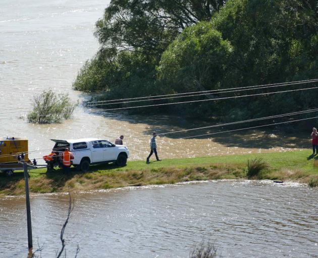 Council contractors pump water from Balclutha's Hospital Rd retention pond to avert a potential...