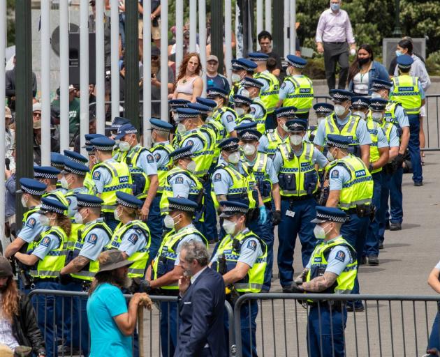 Police officers organise themselves on the Parliament forecourt during the anti-mandate protest....