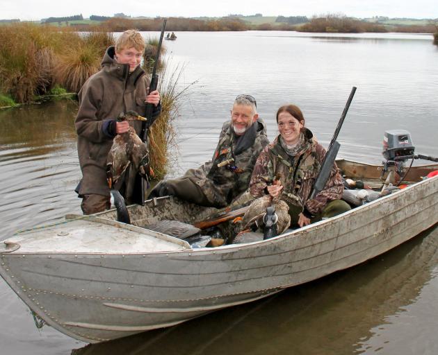 Smiling after a morning that yielded six birds on Lake Tuakitoto, near Kaitangata, are (from left...