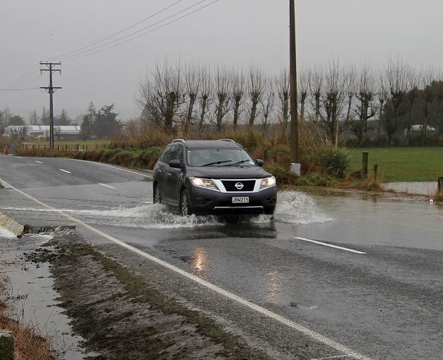 A shallow gulley becomes a creek after heavy rain on Springfield Road, Milton about 1.5km east of...