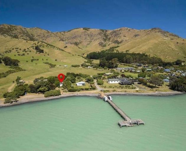 The jetty is just metres from the house in Port Levy. Photo: Supplied 