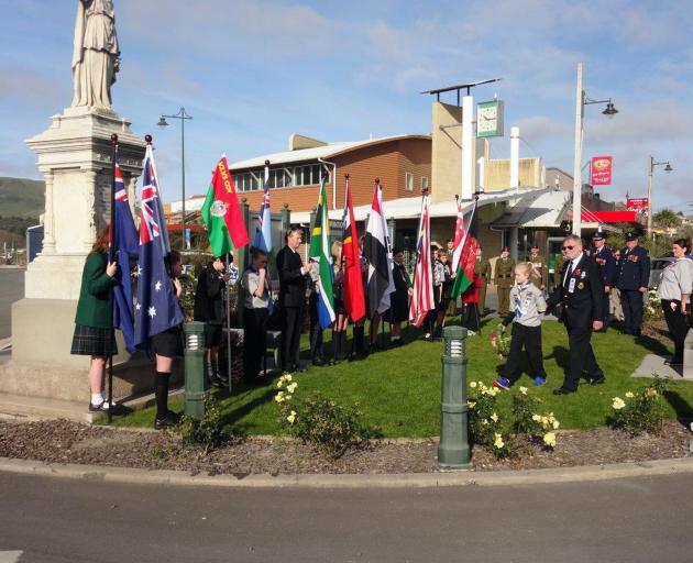 Paige Walker (10), of Palmerston, and Palmerston RSA president Tom Price carry a wreath to be...