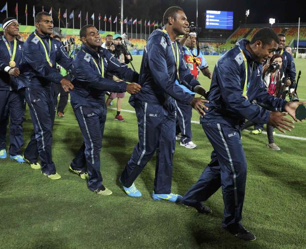 Fiji's sevens' players celebrate with their gold medals. Photo: Reuters