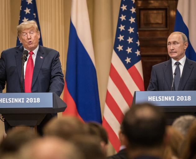 US President Donald Trump speaks during a joint news conference with Russia's President Vladimir...