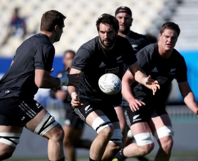 Sam Whitelock (centre) passes during the All Blacks captain's run at Trafalgar Park yesterday....