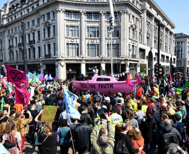 Climate change campaigners co-ordinated by the Extinction Rebellion group block Oxford Circus, in...