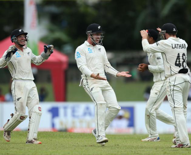 Tom Latham (right) celebrates with his teammates after taking wicket of Niroshan Dickwella. Photo...