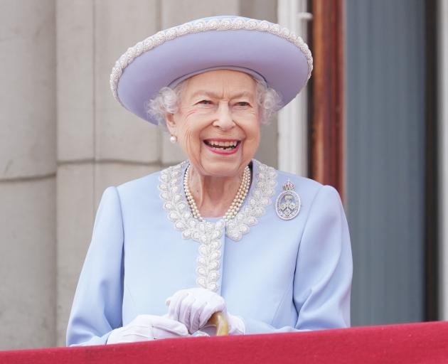 Queen Elizabeth II watches from the balcony of Buckingham Palace during the Trooping the Colour...