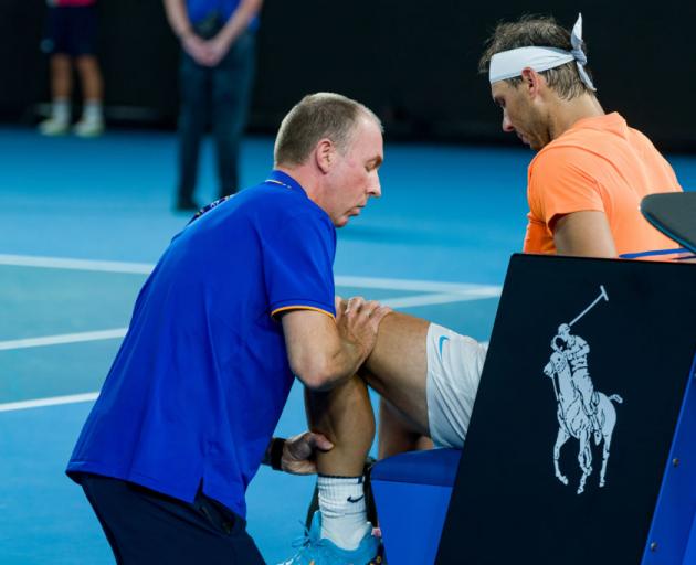 Rafael Nadal receiving medical attention in his round two singles match at the Australian Open in...