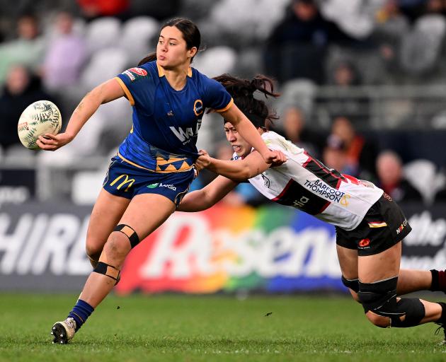 Maia Joesph of Otago offloads the ball during the round eight Farah Palmer Cup match against...