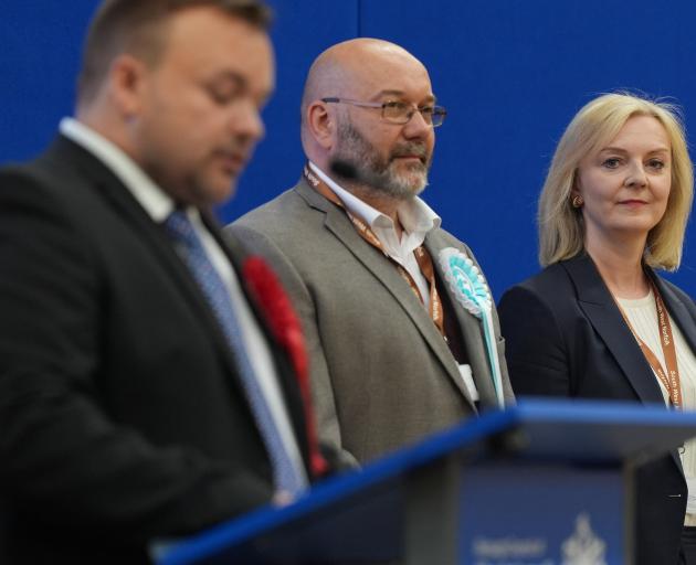 Former PM Liz Truss looks on as the Labour candidate gives his acceptance speech in her former...