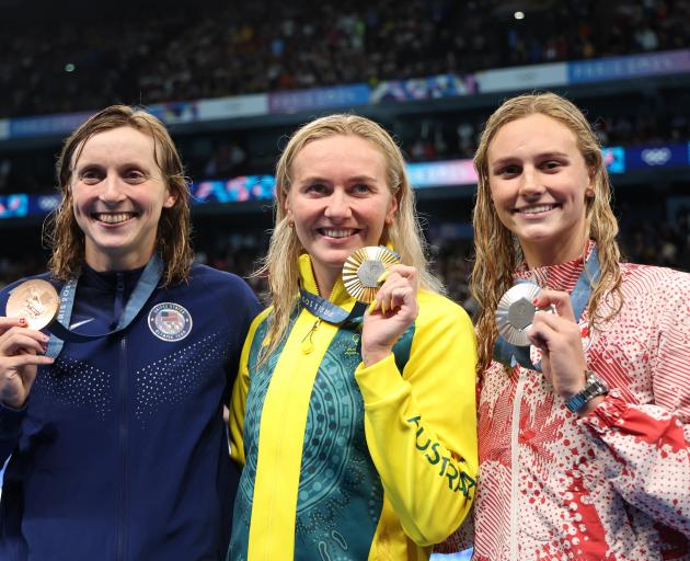 From left: Kate Ledecky, Ariarne Titmus and Summer McIntosh celebrate with their medals in the...