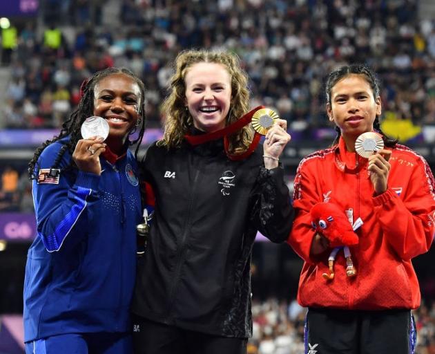 Brittni Mason, left,  Anna Grimaldi and Sasirawan Inthachot celebrate their success on the podium...