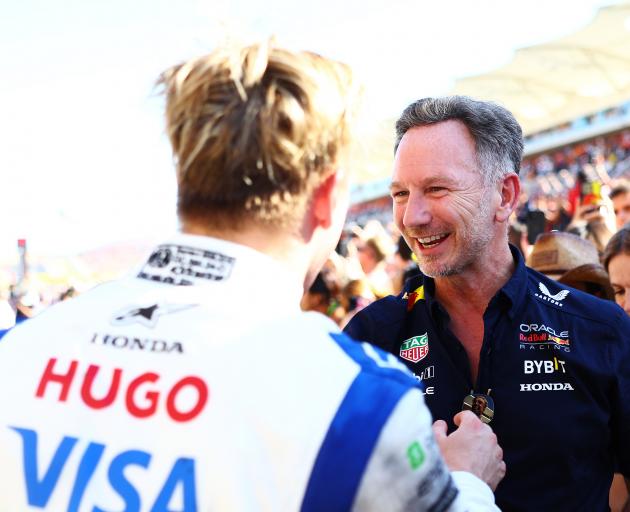 Liam Lawson is congratulated by Red Bull team principal Christian Horner following his top ten...