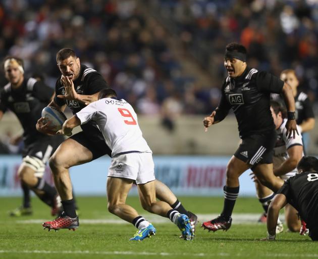 Ben May of the Maori All Blacks fends off a tackle from a US Eagles player at Toyota Park in...