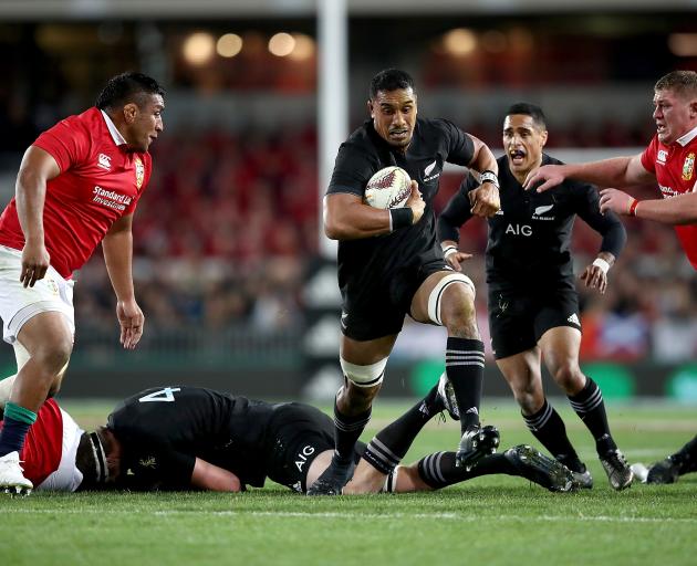 All Black Jerome Kaino (centre) makes a break during the first Test againts the British and Irish...