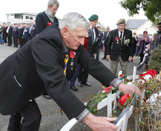 Watched by other veterans Private Pat Blair, who served in Malaya and Vietnam, lays a wreath at...