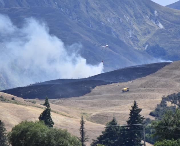 Three helicopters were called in to help fight the blaze. Photo: Becki Bentley