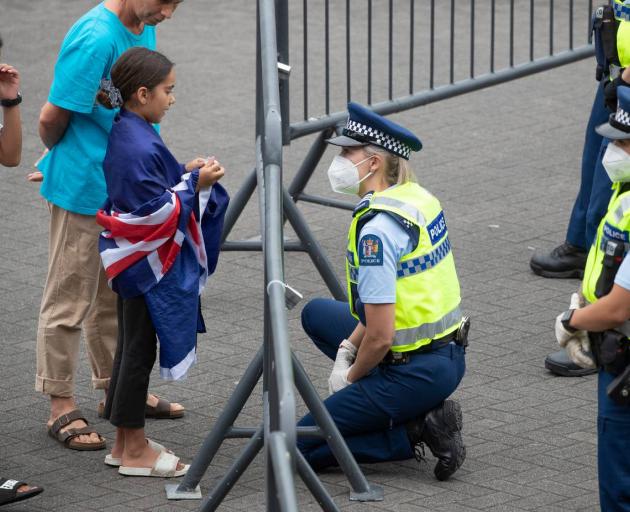 It was a mostly peaceful day, evidenced here with a police officer talking to a child during the...