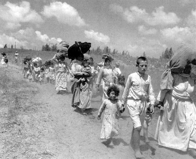 Palestinian women and children driven from their homes by Israeli forces in 1948, part of an...