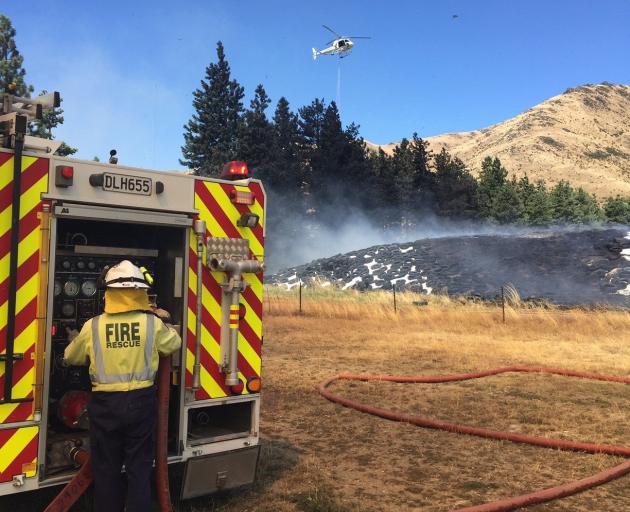 Fire crews battle a large hay-bale fire in Broken Hut Rd, near Omarama, yesterday. PHOTO: SUPPLIED