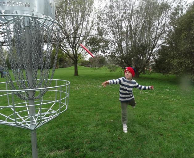 Oamaru-based Eli Ferguson, 6, tries out disc golf on the opening day at Weston Domain with his...