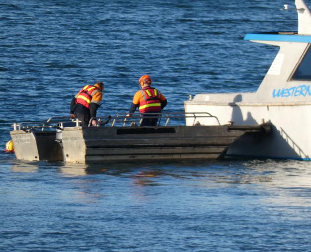 Rescuers at the boat. Photo: Max Quinn