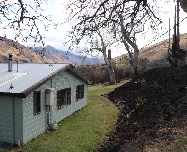 Only a few metres of grass separates Mr Mills' house at Deep Creek from the fire line. PHOTOS:...