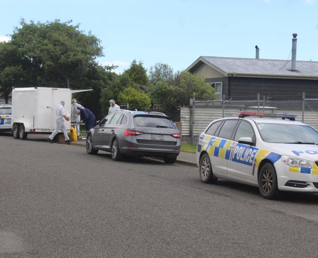 Police and forensic personnel conduct an examination of the Invercargill property where a serious...