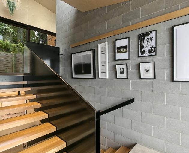 Concrete, metal and wood feature throughout the home. The stairs are American oak.