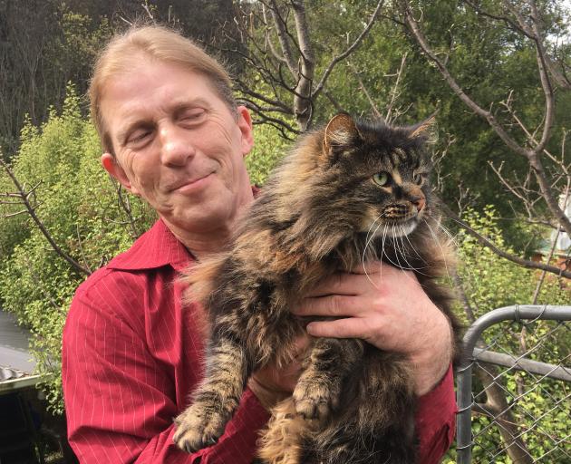 Alex Kerr and his cat, Dusty, outside their Dunedin home. PHOTO: SHAWN MCAVINUE

