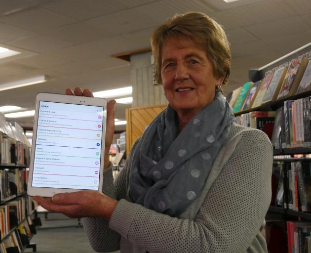 LinkAge working group consumer representative Juliet Kenworthy holds a tablet with the new...