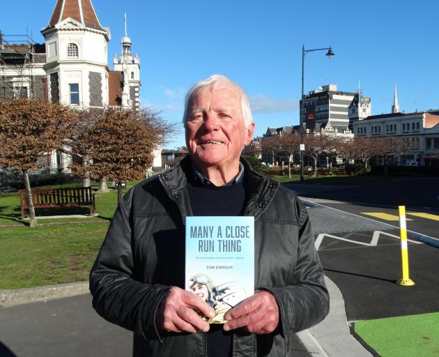 Dunedin author Tom Enright holds a copy of his memoir Many A Close Run Thing, about his life as...