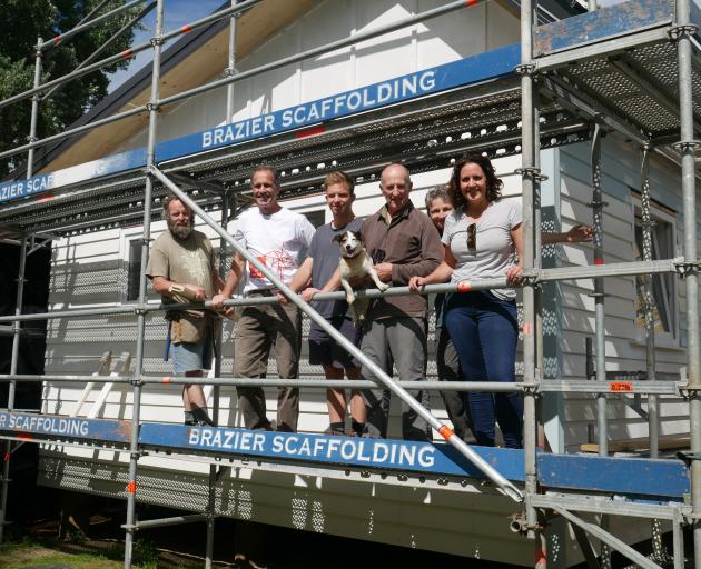 On site at the climate-safe house building site are (from left) volunteer Gerry Thompson,...