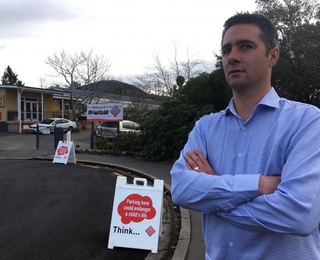 Fairfield School principal Greg Lees uses signs in Sickels St to encourage people to park legally...