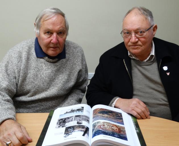 Dunedin RSA president Lox Kellas (left) and veteran Gary Shields look over The Vietnam Scrapbook...