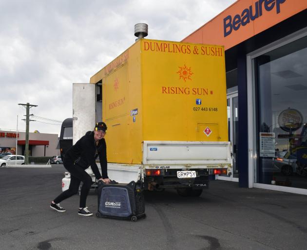 Dunedin Food Truck Market organiser Catherine Page, of East Taieri, rolls a generator as she sets...