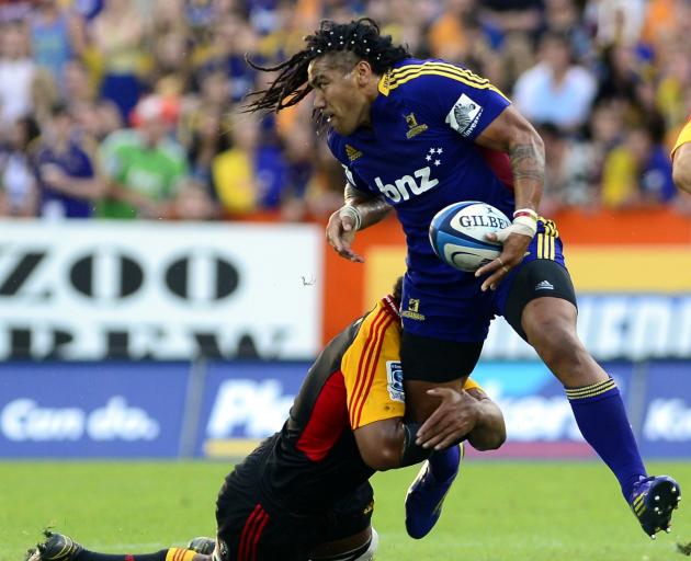 Highlander Ma'a Nonu is held by Chiefs prop Ben Afeaki during the Super 15 Rugby match held at...