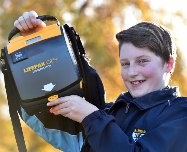 King's High School year 9 pupil Jaimin Armstrong with the school's new defibrillator. Photo: Peter McIntosh.