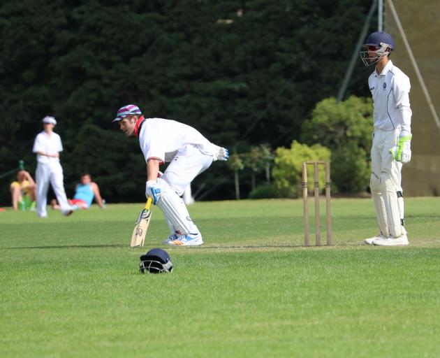 Former All Black captain Richie McCaw turns for a run while Otago Boys' High School wicketkeeper Max Chu awaits developments at the Willows ground in central Canterbury on Sunday. Photo: Supplied