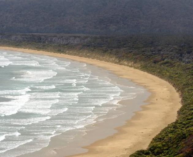 A person has the beach to themself at Tautuku Bay (below) on the Southern Scenic Route.