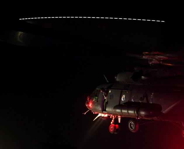 A military helicopter carrying rescued schoolboys approaches to land at a military airport in...