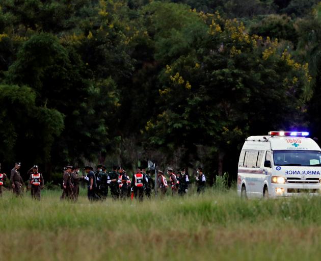 An ambulance carrying rescued schoolboys leaves a military airport in Chiang Rai. Photo: Reuters