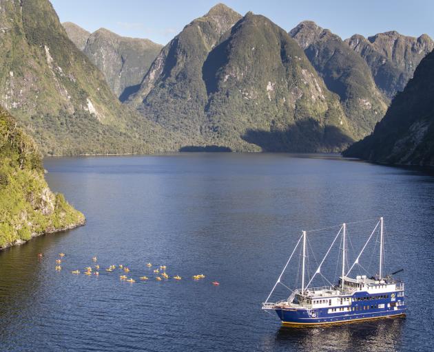 Kayakers from Real Journeys' 40m vessel Fiordland Navigator head off to explore Doubtful Sound. Photo: Supplied